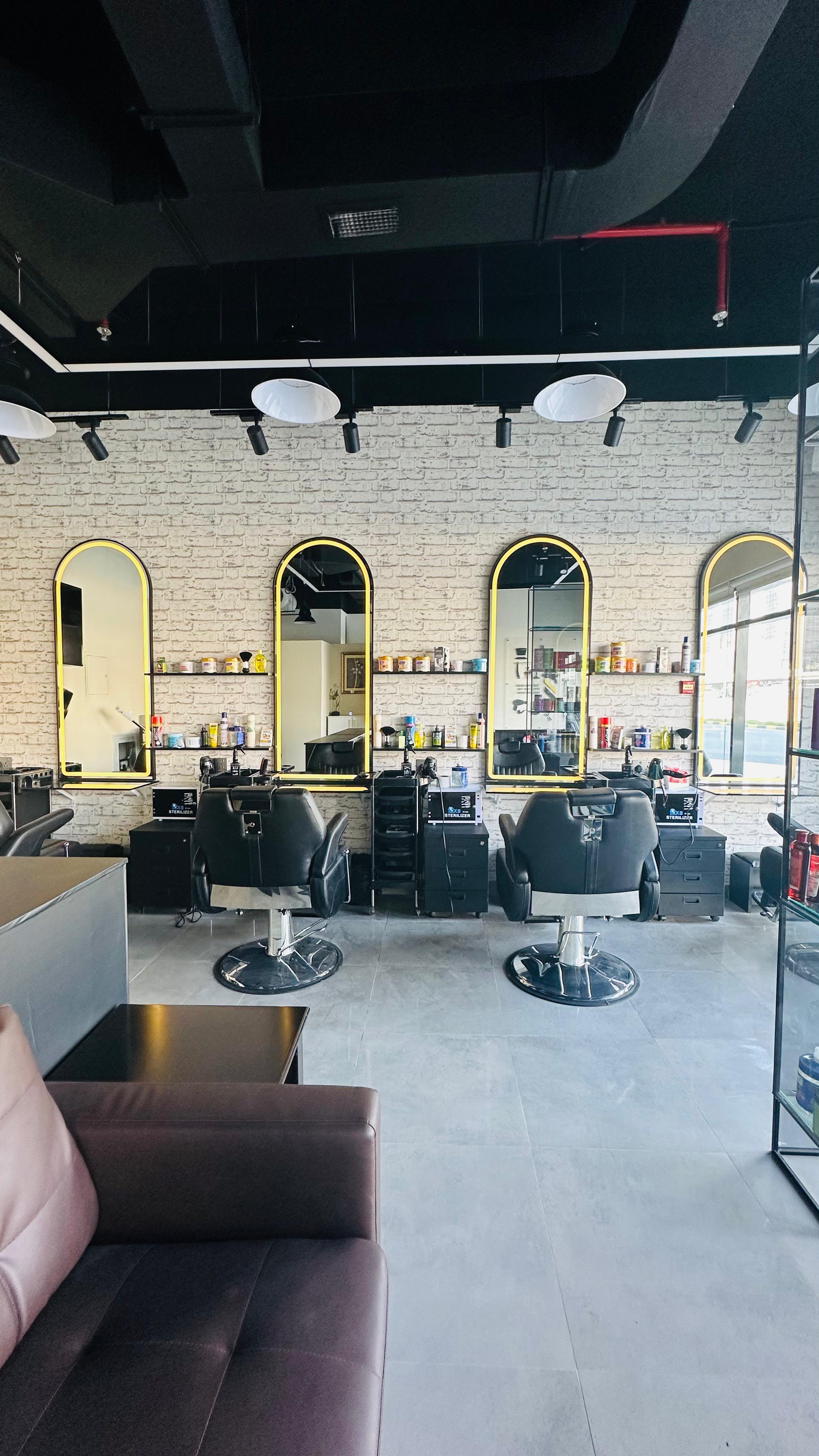 Wide view of the barbershop interior with four chairs
