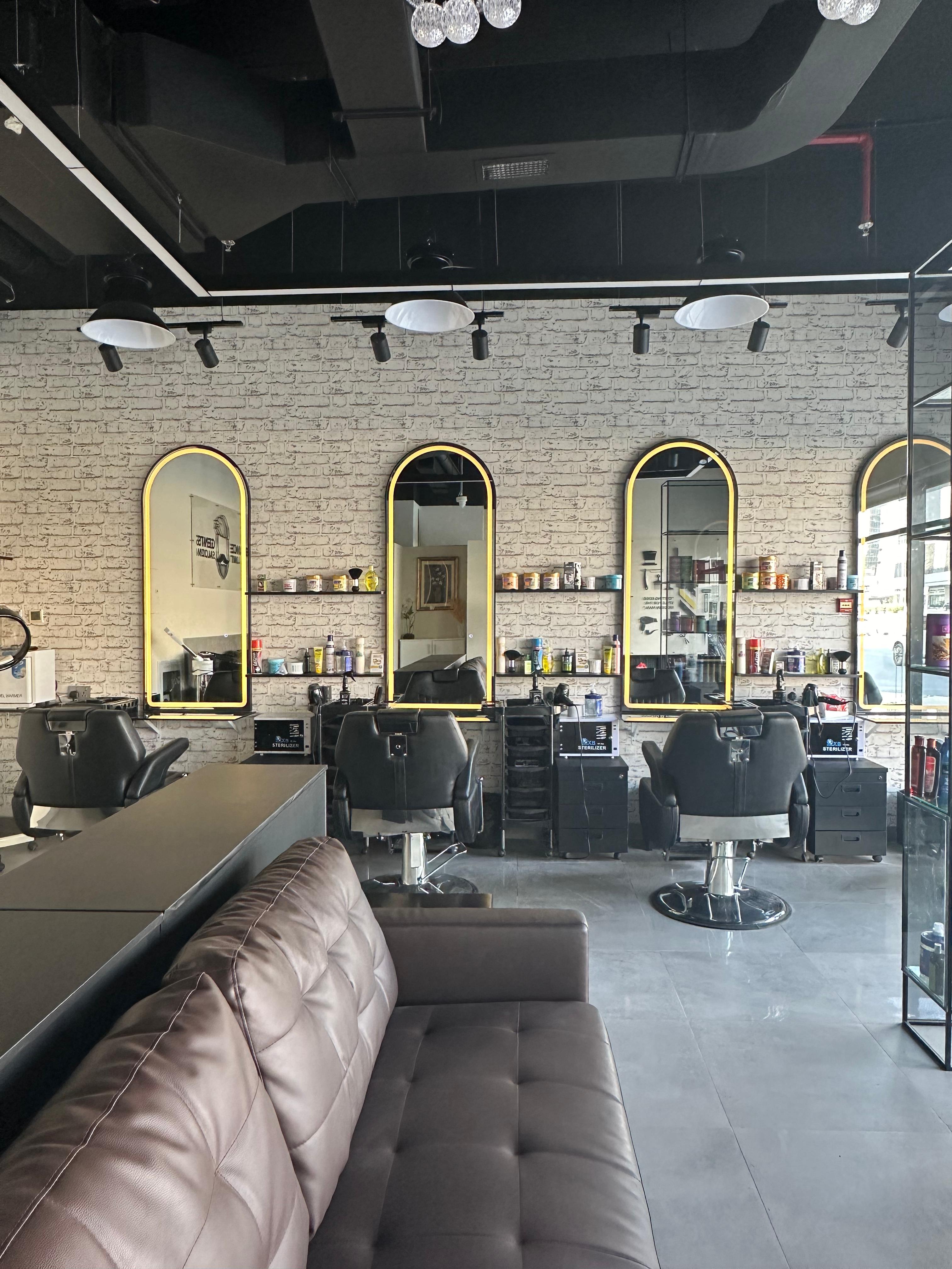 Barber chairs and arched mirrors with tufted leather couch
